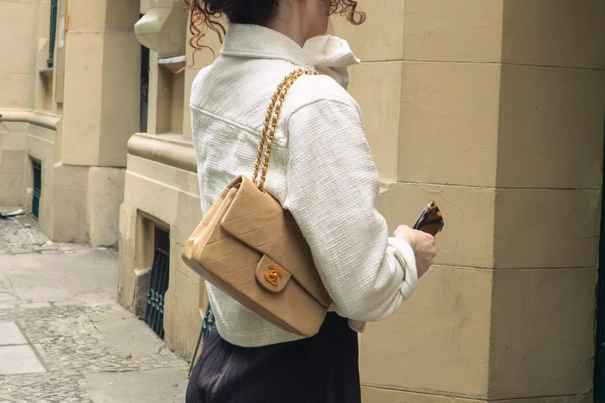 beige vintage small classic flap worn over shoulder